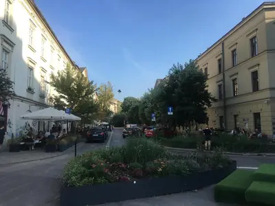 a city street with buildings and people sitting at tables at Sunny Studio Mostowa Krakow Kazimierz by Nolegi Renters in Kraków