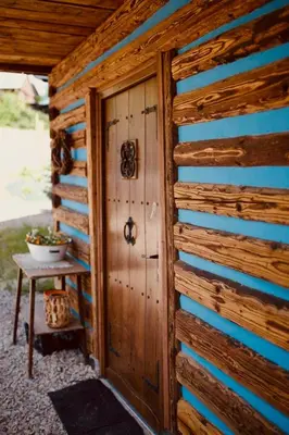 a wooden shed with a door and a table at Ranczo nad Cedronem in Kalwaria Zebrzydowska