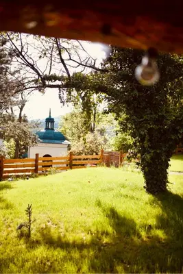 a view of a field with a fence and a building at Ranczo nad Cedronem in Kalwaria Zebrzydowska