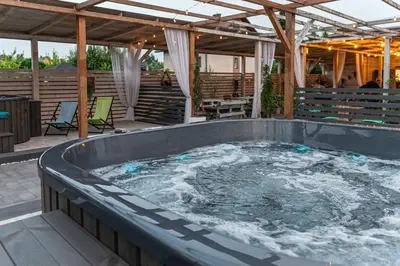 a hot tub in the middle of a patio at Old Tree Home & Restaurant in Oświęcim