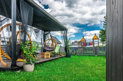 a gazebo with a playground in the background at Old Tree Home & Restaurant in Oświęcim