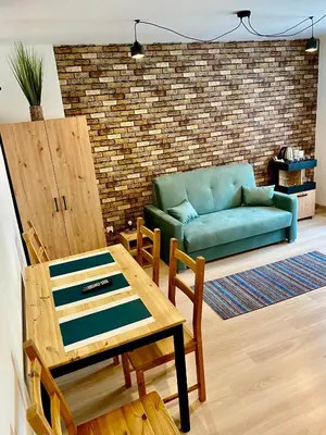 a living room with a couch and a table at Old Tree Home & Restaurant in Oświęcim