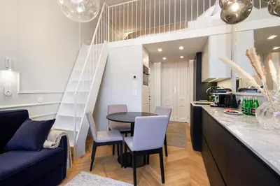 a kitchen and living room with a table and chairs at Polish design in Kraków