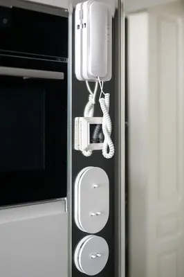 a refrigerator with a phone and a microwave at Polish design in Kraków