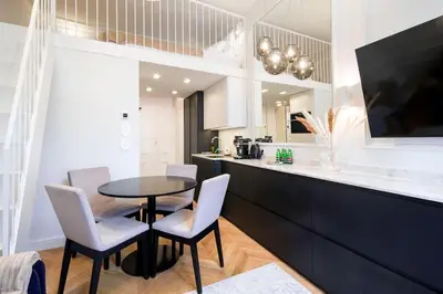 a kitchen with a table and chairs and a counter at Polish design in Kraków