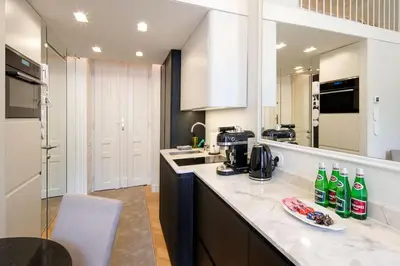 a kitchen with a counter with soda bottles on it at Polish design in Kraków