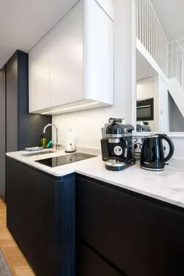 a kitchen with a black and white counter top at Polish design in Kraków