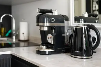 a coffee maker is sitting on a kitchen counter at Polish design in Kraków