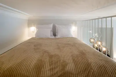 a bedroom with a large bed with white pillows at Polish design in Kraków