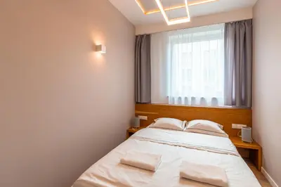 a bedroom with a bed and a window at Old Town Standard Apartment by BookingHost in Kraków