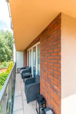 a balcony with chairs and a brick wall at Old Town Standard Apartment by BookingHost in Kraków