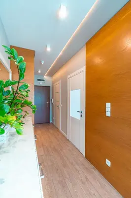 an empty room with a hallway with wood paneling at Old Town Standard Apartment by BookingHost in Kraków