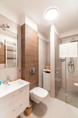 a bathroom with a toilet and a sink and a shower at Old Town Standard Apartment by BookingHost in Kraków