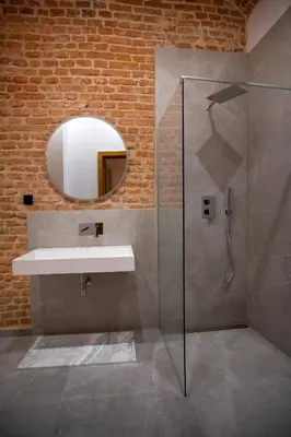 a bathroom with a sink and a mirror at HOTEL TEATR in Kraków