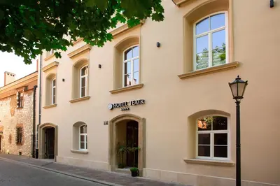 a building with a street light in front of it at HOTEL TEATR in Kraków