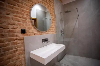 a bathroom with a white sink and a mirror at HOTEL TEATR in Kraków