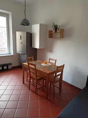 a living room with a blue couch and a table at Plantyna in Kraków