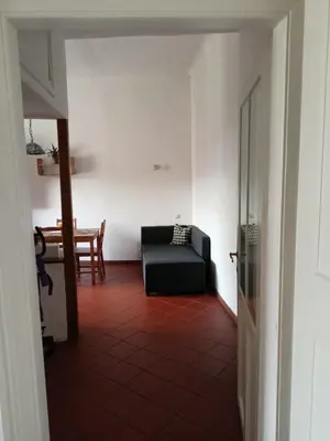 a bedroom with a bed in a room with a table at Plantyna in Kraków