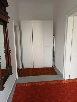 a kitchen with a table and chairs and a refrigerator at Plantyna in Kraków