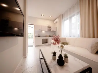 a living room with a white couch and a table at Sweet Dreams Apartment in Zator