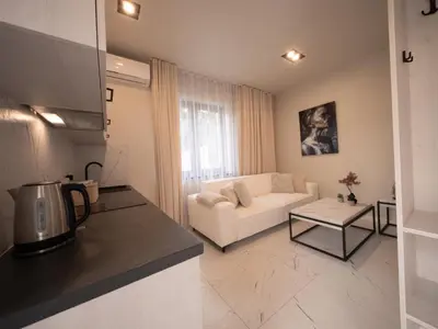 a living room with a white couch and a table at Sweet Dreams Apartment in Zator