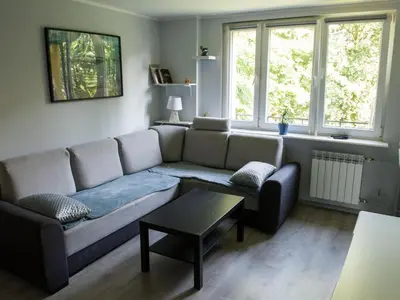 a living room with a couch and a table at Pod Wielorybem in Jaworzno