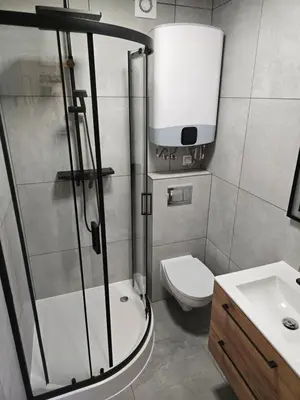 a bathroom with a shower and a toilet and a sink at DOMKI#ENERGY Zator in Przeciszów
