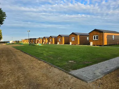 a row of houses in a park with a grass field at DOMKI#ENERGY Zator in Przeciszów