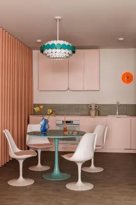 a kitchen with a table and chairs and a chandelier at Pops Apartment in Kraków