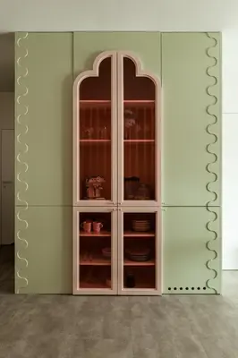 a white cabinet with dishes in it at Pops Apartment in Kraków