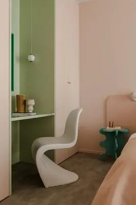a bedroom with a white chair next to a bed at Pops Apartment in Kraków