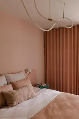 a bedroom with a bed and a chandelier at Pops Apartment in Kraków