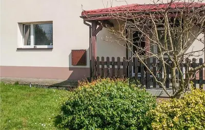 a house with a fence and a window at 3 Bedroom Awesome Apartment In Klucze in Klucze
