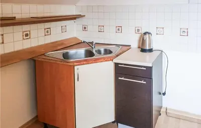 a small kitchen with a sink and a refrigerator at 3 Bedroom Awesome Apartment In Klucze in Klucze