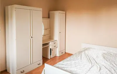 a white bedroom with a bed and a closet at 3 Bedroom Awesome Apartment In Klucze in Klucze