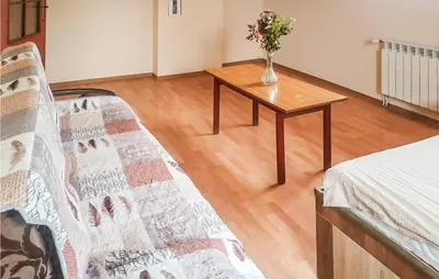 a living room with a couch and a table with flowers at 3 Bedroom Awesome Apartment In Klucze in Klucze