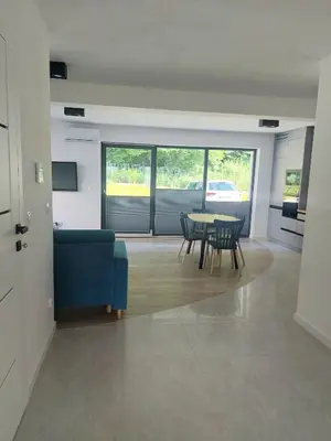 a living room with a blue couch and a table at Apartament na Osiedlu Zielone Zarabie in Myślenice
