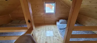 an attic room with two bunk beds and a window at Noclegi u Eli Zator Energylandia in Zator