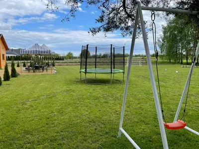 an empty swing set in a yard with a table at Noclegi u Eli Zator Energylandia in Zator