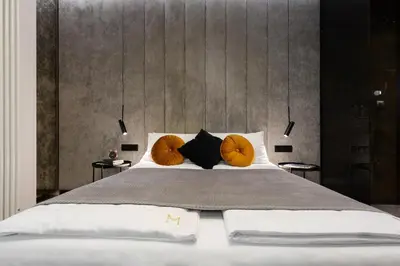 a bedroom with a large bed with orange pillows at Old Town G6 by M Apartments in Kraków