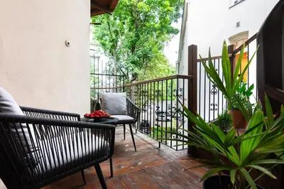 a balcony with two chairs and a table at Old Town G6 by M Apartments in Kraków