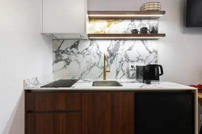 a kitchen with a sink and a counter top at Old Town G6 by M Apartments in Kraków