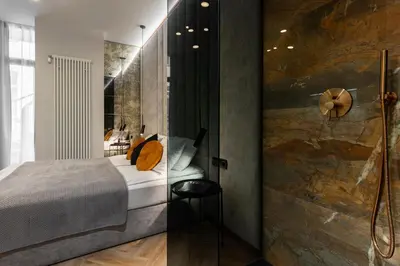 a bedroom with a bed and a glass shower at Old Town G6 by M Apartments in Kraków