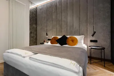 a bedroom with a large bed with orange pillows at Old Town G6 by M Apartments in Kraków
