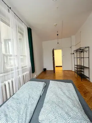 a bedroom with a bed and a large window at Nice View Rooms In Old Town in Kraków