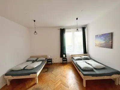 two twin beds in a room with a window at Nice View Rooms In Old Town in Kraków