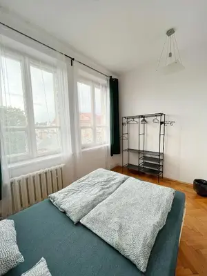 a bedroom with a bed in a room with windows at Nice View Rooms In Old Town in Kraków