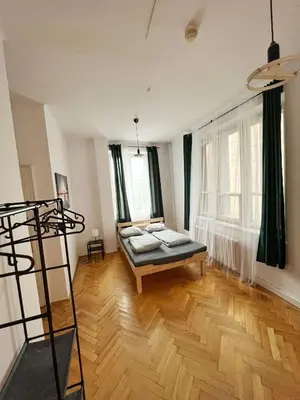 a room with a bed in the middle of a room at Nice View Rooms In Old Town in Kraków