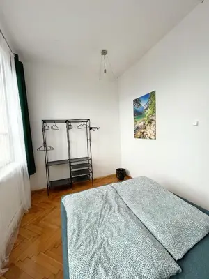 a bedroom with a bed and a picture on the wall at Nice View Rooms In Old Town in Kraków