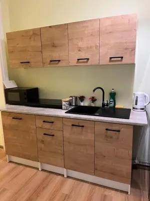 a kitchen counter with a sink and a microwave at Batorego Lovely Rooms in Kraków